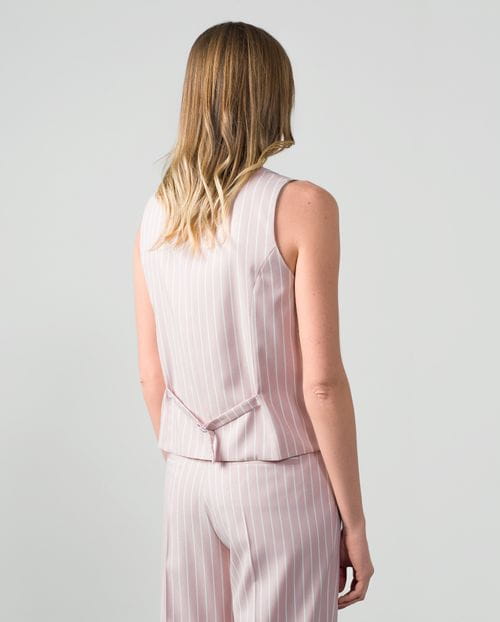 Fitted tailored gilet in ivory pinstripes with lurex thread on dusty pink background