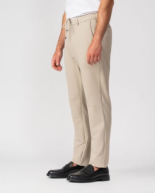 Trousers with drawstring and elastic waistband, made of stretch technical fabric