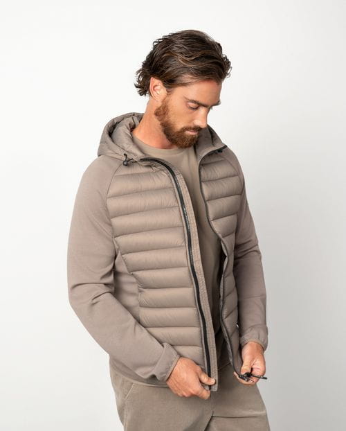 Ultra-light weight quilted hooded jacket combining technical fabric and foam