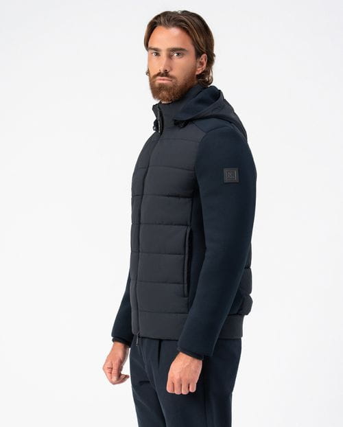 <p>Quilted jacket combining technical fabric and knit, with detachable hood</p>