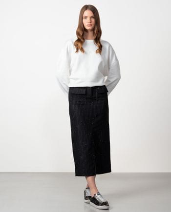 Straight midi skirt with patch pockets and front vent made from wool twill fabric with pintripe pattern