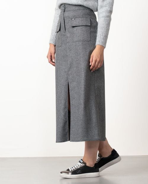 Straight midi skirt with patch pockets and front vent  made from cheviot wool fabric